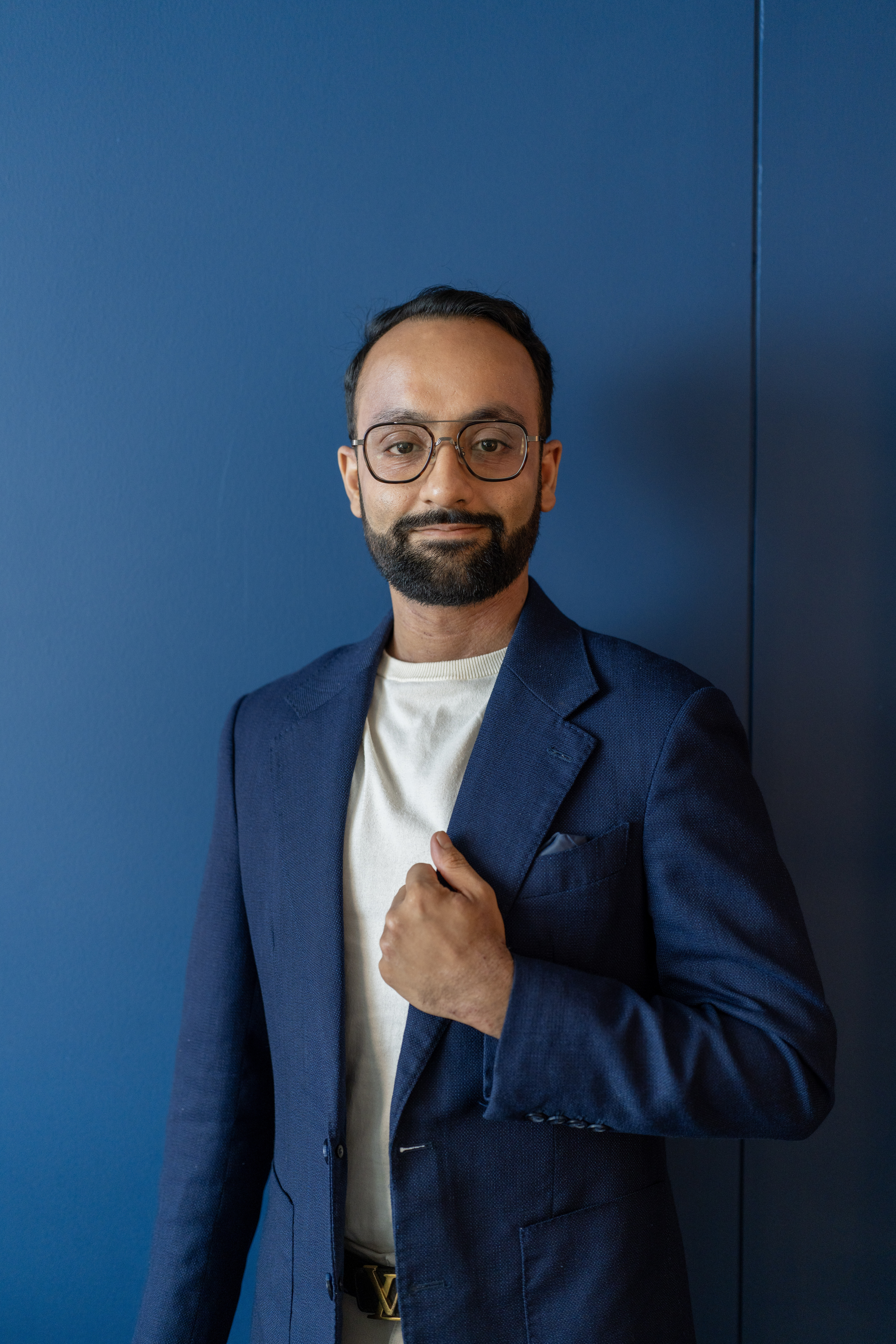 man in blue suit white shirt